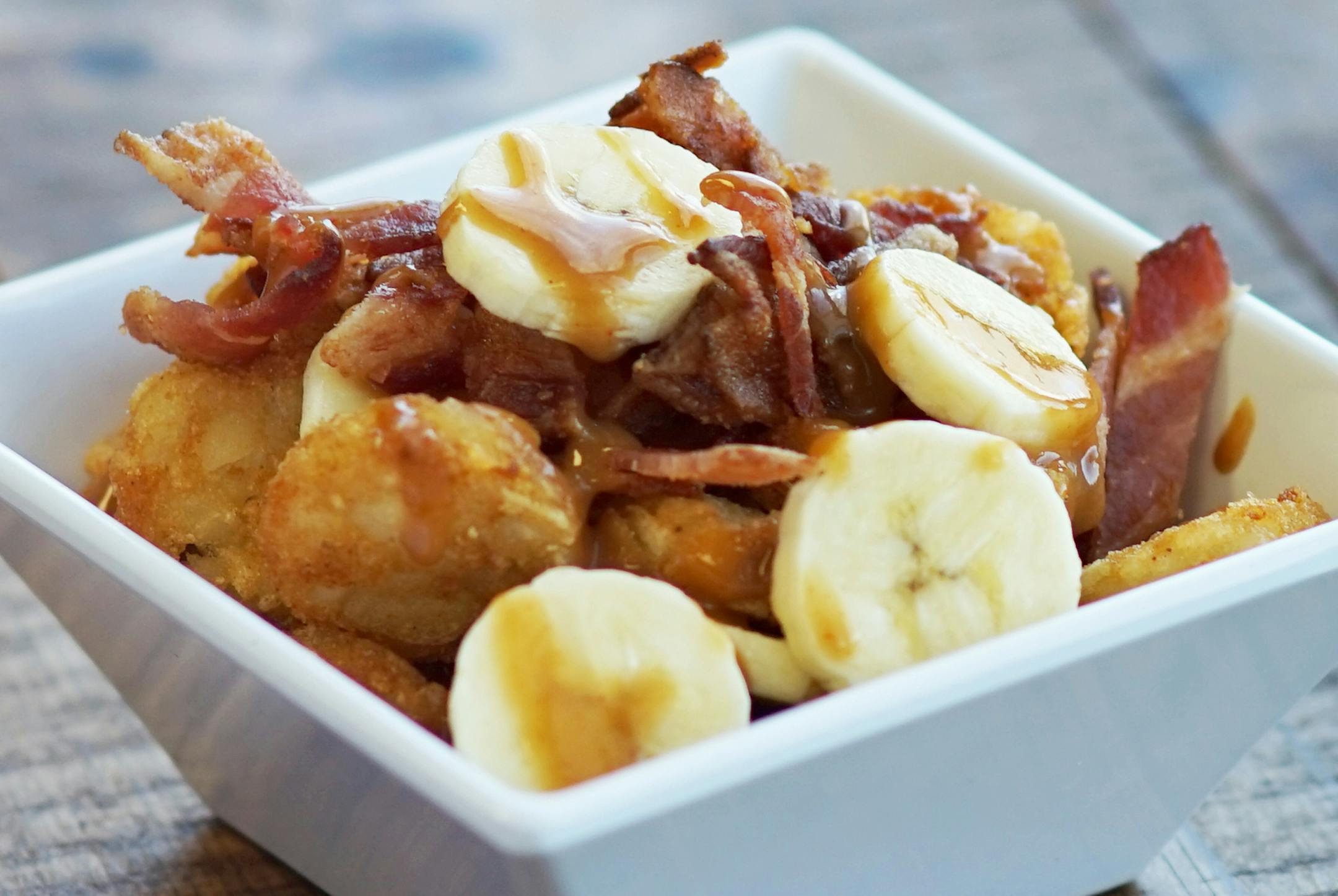 One of the new foods coming to the State Fair: Memphis Totchos (sliced bananas and saut&#xc8;ed bacon over tater tots, topped with peanut sauce) at Snack House, located in the Warner Coliseum.