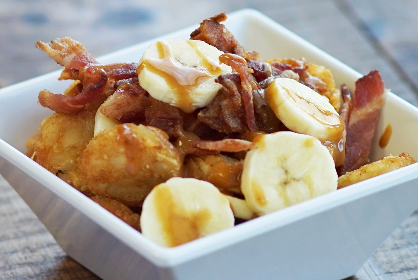 One of the new foods coming to the State Fair: Memphis Totchos (sliced bananas and saut&#xc8;ed bacon over tater tots, topped with peanut sauce) at Snack House, located in the Warner Coliseum.