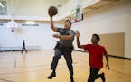 Officer Pheng Xiong played basketball with Ronnie Kemp, 15, at the Arlington Hills Community Center Friday. Xiong stops in at the center every day on 