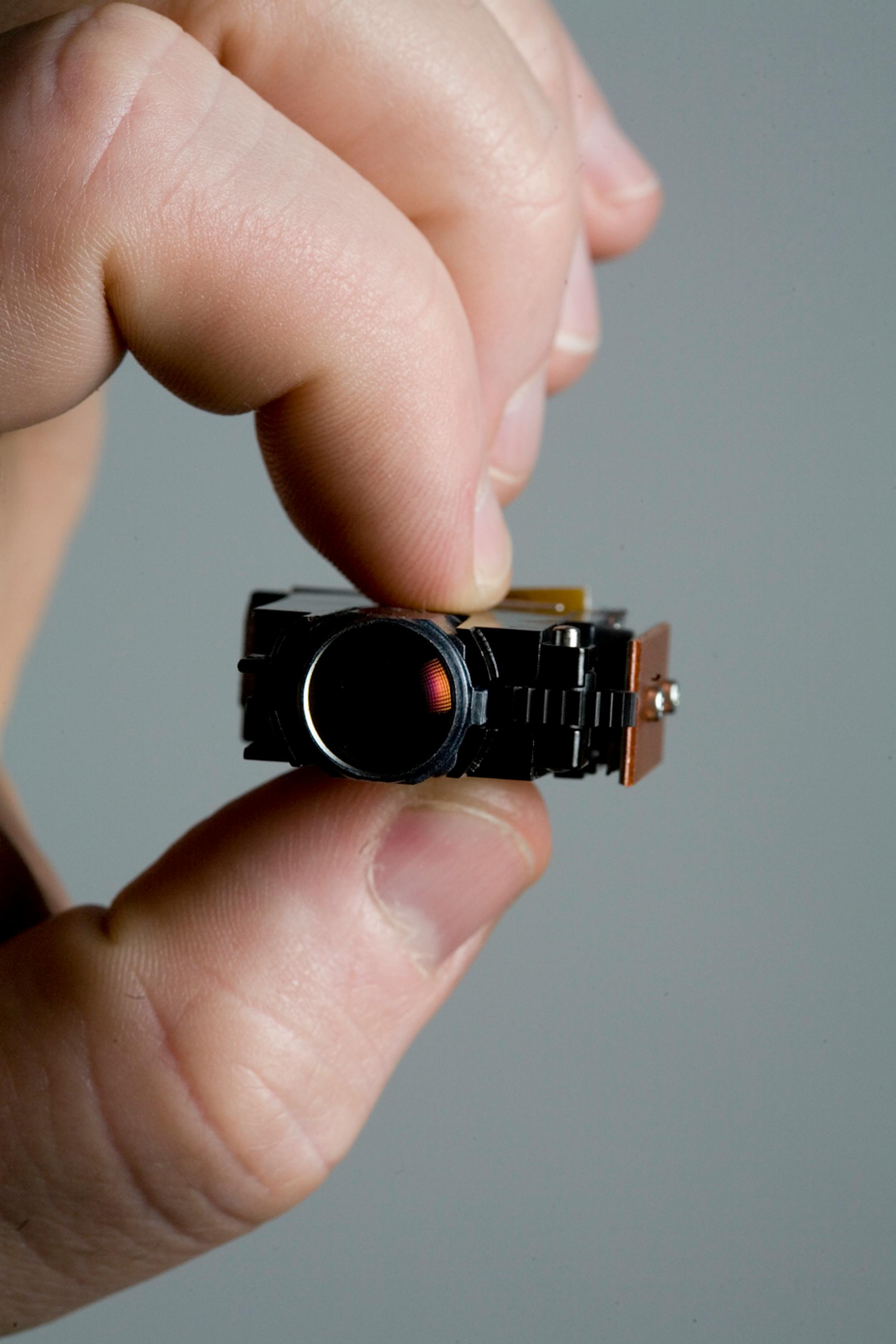 The projector displays digital photos on surfaces. Samsung will be the first big customer.