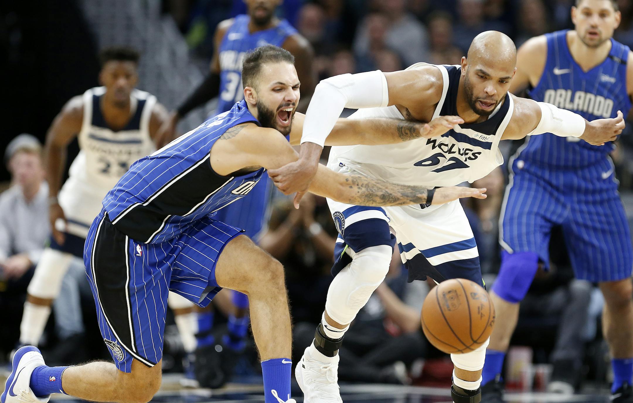 Minnesota Timberwolves forward Taj Gibson (67) and Orlando Magic forward Evan Fournier (10) chase a loose ball during the second half. ] LEILA NAVIDI ï leila.navidi@startribune.com BACKGROUND INFORMATION: Minnesota Timberwolves against Orlando Magic at Target Center in Minneapolis on Wednesday, November 22, 2017.