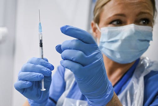 Paula McMahon prepares a shot of the Pfizer-BioNTech COVID-19 vaccine, as the mass public vaccination program gets underway, at the NHS Louisa Jordan Hospital in Glasgow, Scotland.