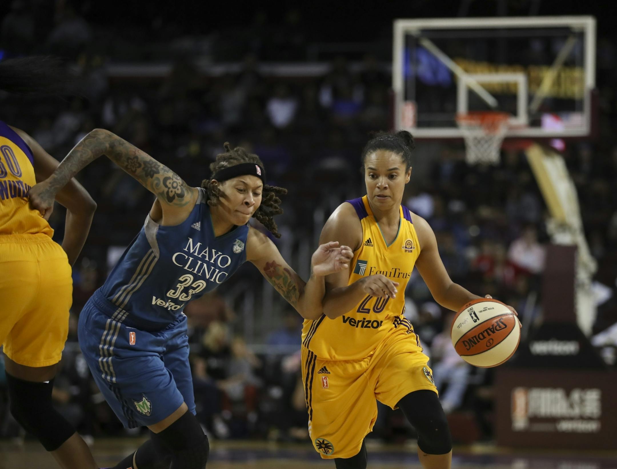 Minnesota Lynx guard Seimone Augustus (33) guarded Los Angeles Sparks guard Kristi Toliver (20) as she moved the ball in the fourth quarter.