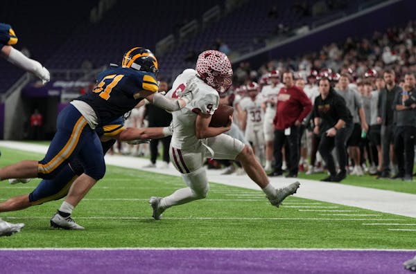 Maple Grove Crimson quarterback Jacob Kilzer (9) is ousted out of bounds at the one yard line in the second half. Rosemount Irish played the Maple Gro
