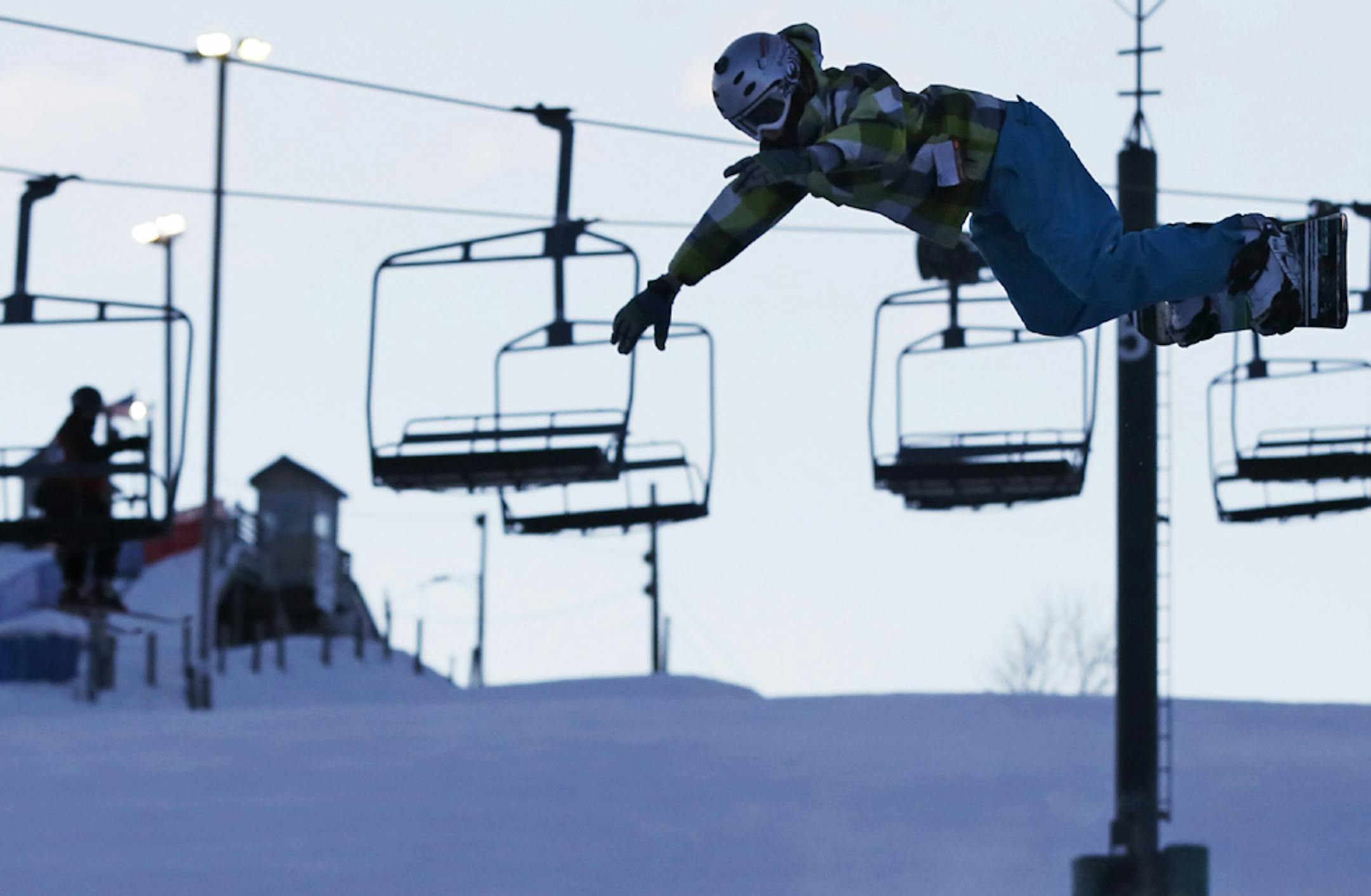At the Buck Hill ski area in Burnsville, snowboarder Connor Bennett, 12, of Lakeville, practiced backflips Monday — with a giant inflatable landing pad to catch him while he aired it out. The Twin Cities temperature on the last day of 2012 hit its high point at 18 degrees just after midnight.