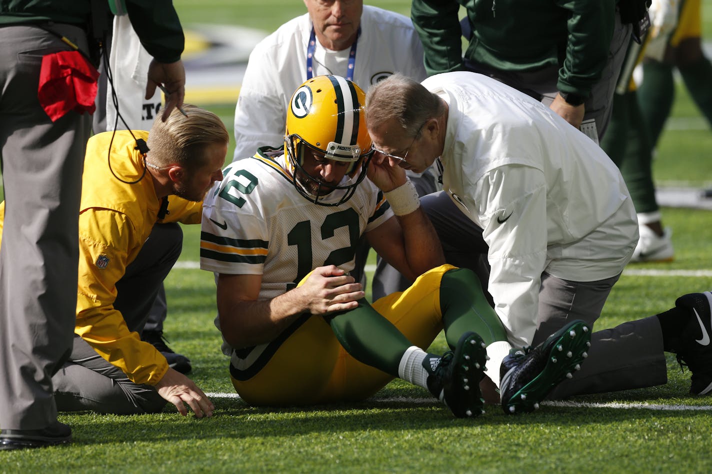 Green Bay Packers quarterback Aaron Rodgers gets up after being hit by Minnesota Vikings outside linebacker Anthony Barr (55) in the first half of an NFL football game in Minneapolis, Sunday, Oct. 15, 2017. (AP Photo/Jim Mone)