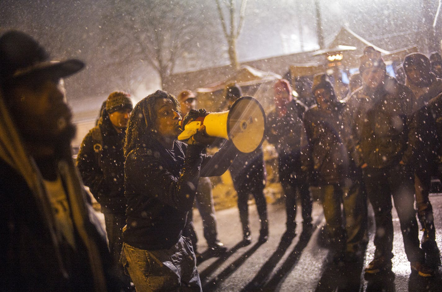 At the 4th Precinct in North Minneapolis, Black Lives Matter protesters anticipated a possible raid on their encampment that evening. Four men were charged Monday, Nov. 30, 2015, in last week's shooting of demonstrators protesting the killing of a black man by Minneapolis police, while the city's mayor separately asked the protesters to end their weekslong encampment at a police precinct. (Richard Tsong-Taatarii/Star Tribune via AP) ORG XMIT: MIN2015120113002322