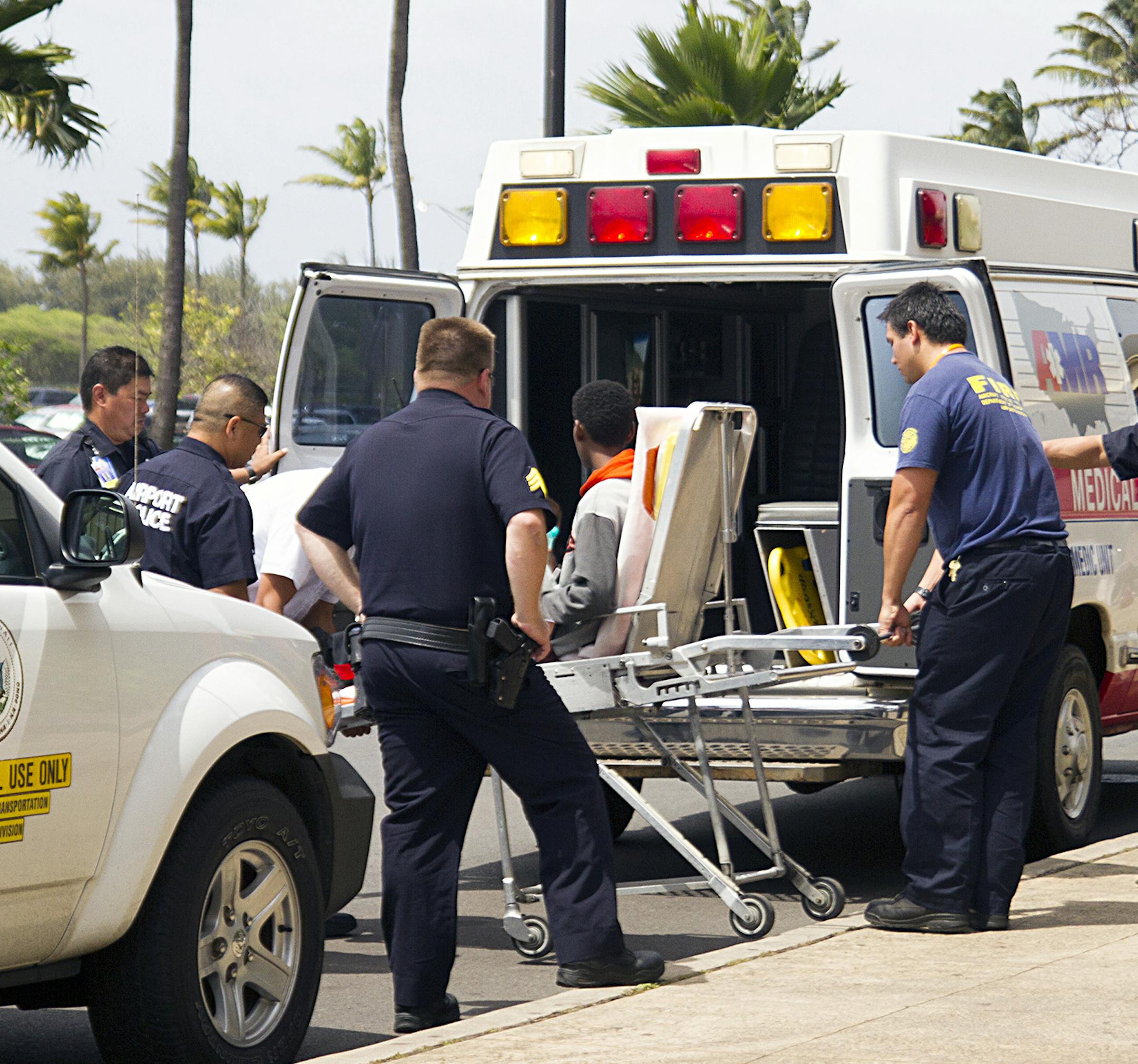 A 15-year-old boy, seen sitting on a stretcher center, who stowed away in the wheel well of a flight from San Jose, Calif., to Maui is loaded into an ambulance at Kahului Airport in Kahului, Maui, Hawaii Sunday afternoon, April 20, 2014. The boy survived the trip halfway across the Pacific Ocean unharmed despite frigid temperatures at 38,000 feet and a lack of oxygen, FBI and airline officials said. FBI spokesman Tom Simon in Honolulu told The Associated Press on Sunday night that the boy was qu