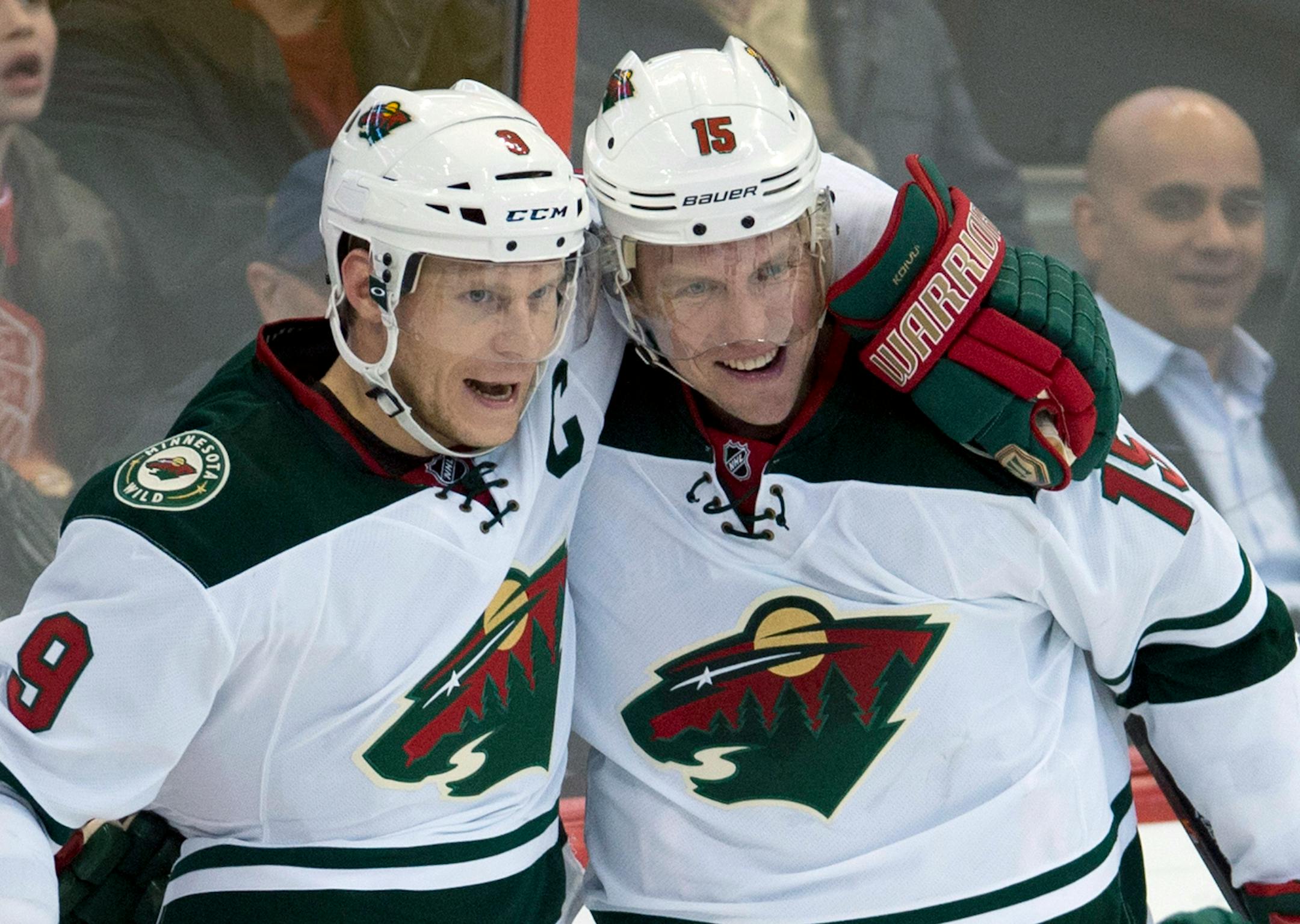Minnesota Wild's Dany Heatley, right, celebrates his goal with teammate Mikko Koivu during the second period of an NHL hockey game in Ottawa, Ontario on Wednesday, Nov. 20, 2013. (AP Photo/The Canadian Press, Adrian Wyld)