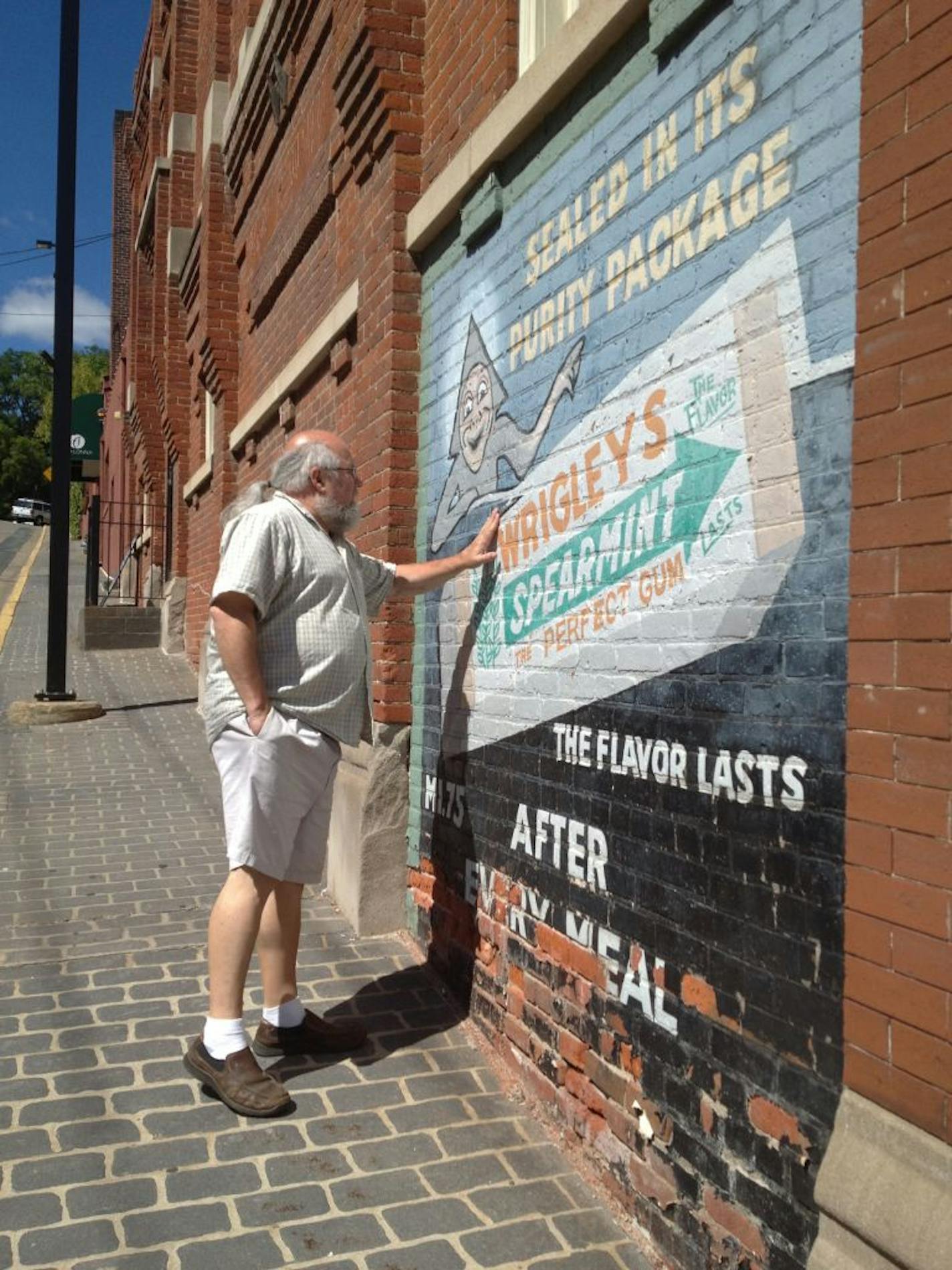 Kaitlyn Walsh
Randall Raduenz near a mural he painted of a Wrigley's chewing gum ad.