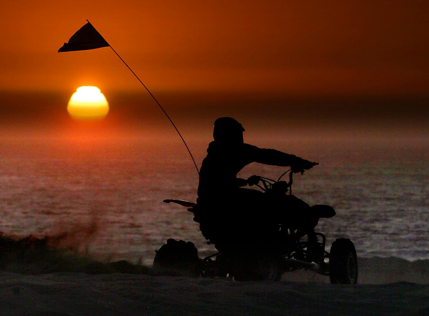 A dramatic setting sun and the Pacific Ocean loomed before ATV riders at the Oceano Dunes State Vehicular Recreation Area in San Luis Obispo, California. ] JIM GEHRZ &#x201a;&#xc4;&#xa2; jgehrz@startribune.com / San Luis Obispo, CA 8/31, 2014 /1:00 PM / BACKGROUND INFORMATION: Trip to San Luis Obispo, CA, to cover ATV scene at Oceano Dunes State Vehicular Recreation Area along the Pacific Ocean. Also interviewed Dr. Larry Foreman, an ER physician at nearby Arroyo Grande Community Hospital about