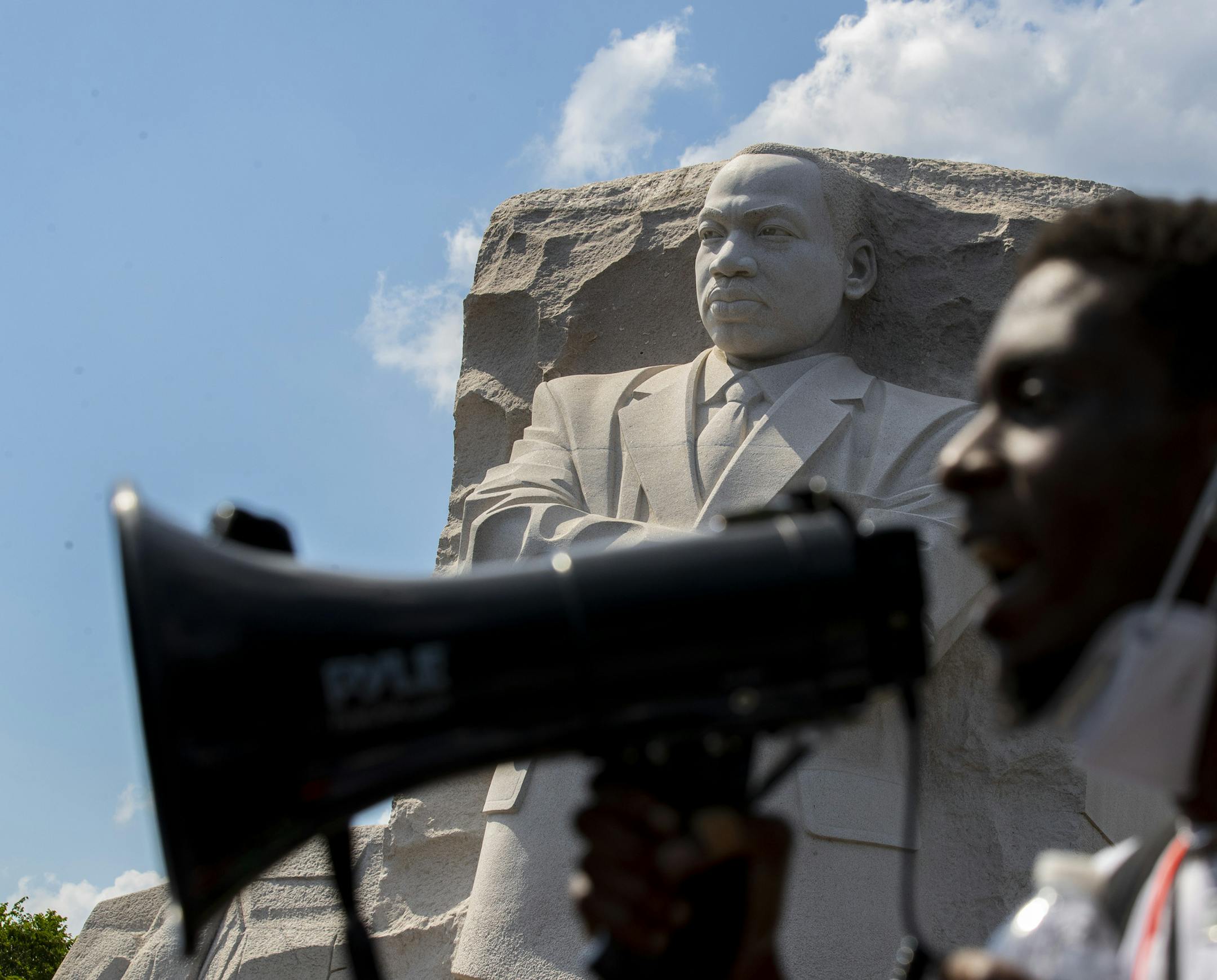 Demonstrators protest Thursday, June 4, 2020, at the Martin Luther King Jr. Memorial in Washington, over the death of George Floyd, a black man who was in police custody in Minneapolis. Floyd died after being restrained by Minneapolis police officers. (AP Photo/Alex Brandon)