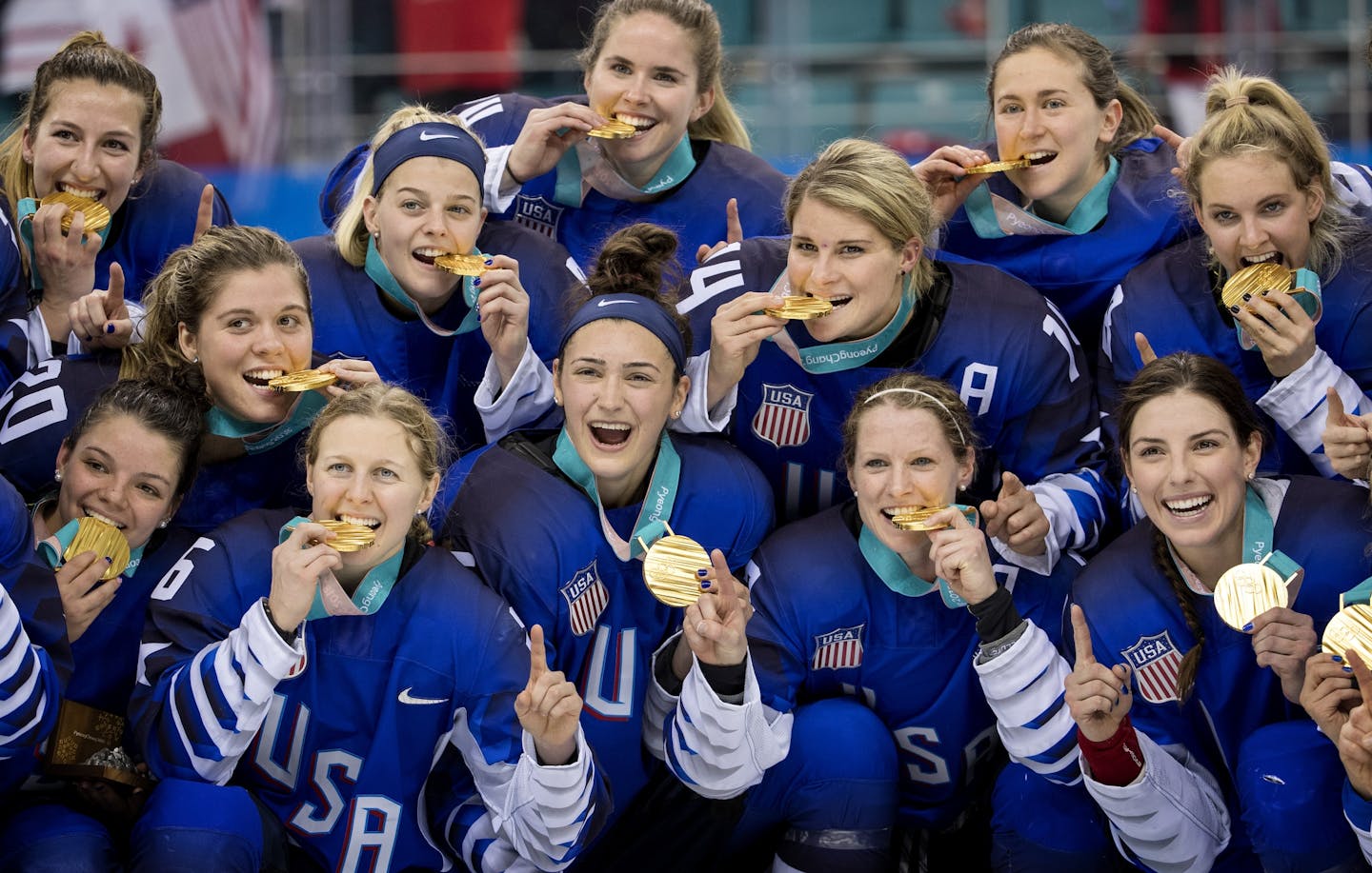 USA players posed with the gold medal after beating Canada in a shootout.