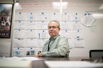 Greg Russ, the director of the Minneapolis Public Housing Authority. Behind him is an action plan of what he hopes to accomplish in Minneapolis.