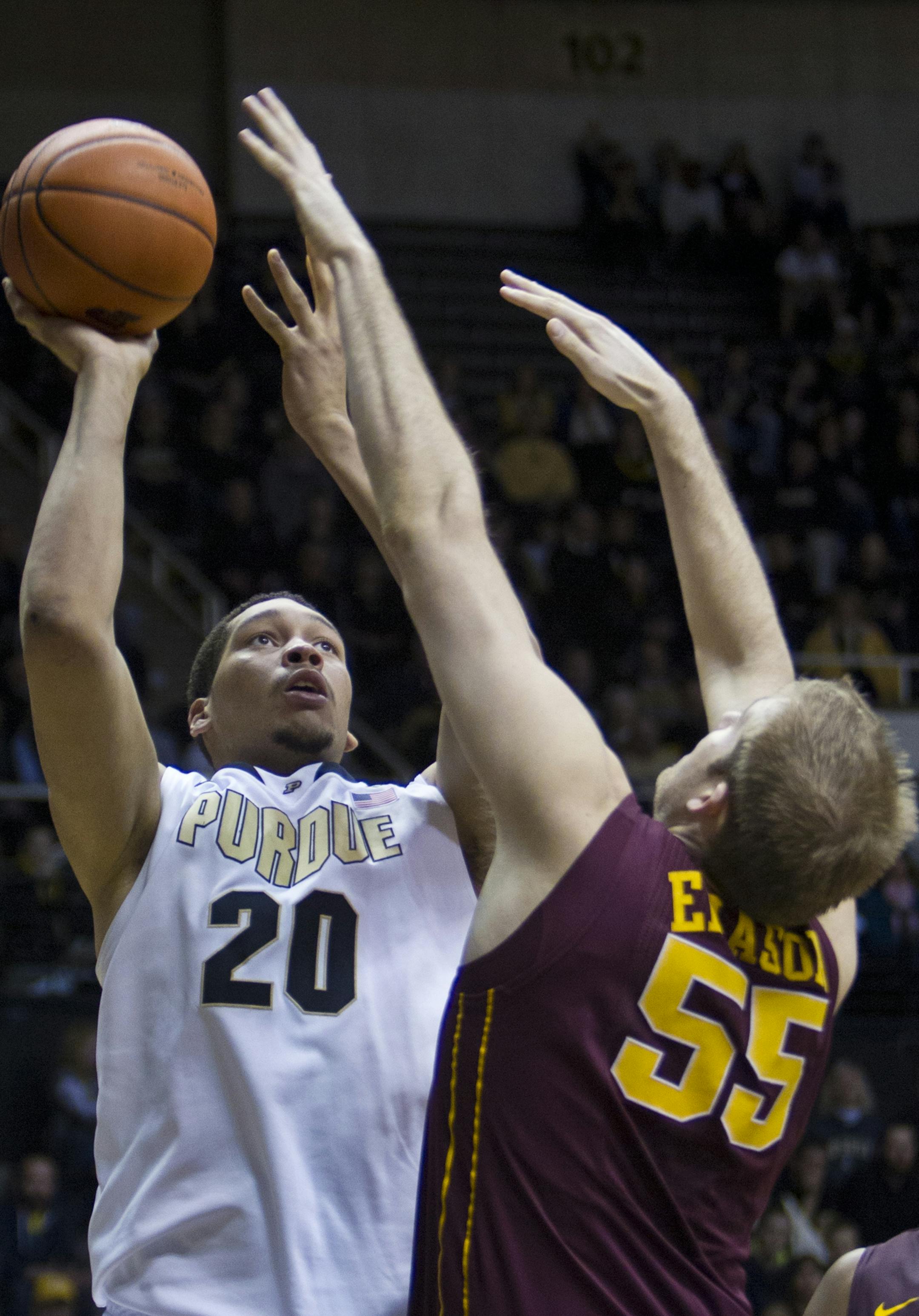 Purdue's A. J. Hammons, left, puts up a shot over Minnesota's Elliot Eliason during an NCAA college basketball game Wednesday, Feb. 5, 2014, at Mackey Arena in West Lafayette, Ind. Purdue won in triple overtime 77-74. (AP Photo/Journal & Courier, Michael Heinz) ORG XMIT: INLAF115