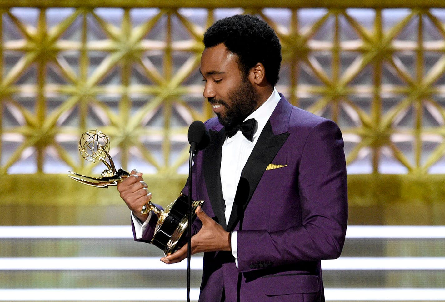 Donald Glover accepts the award for outstanding directing for a comedy series for the "Atlanta" episode "B.A.N." at the 69th Primetime Emmy Awards on Sunday, Sept. 17, 2017, at the Microsoft Theater in Los Angeles. (Photo by Chris Pizzello/Invision/AP)