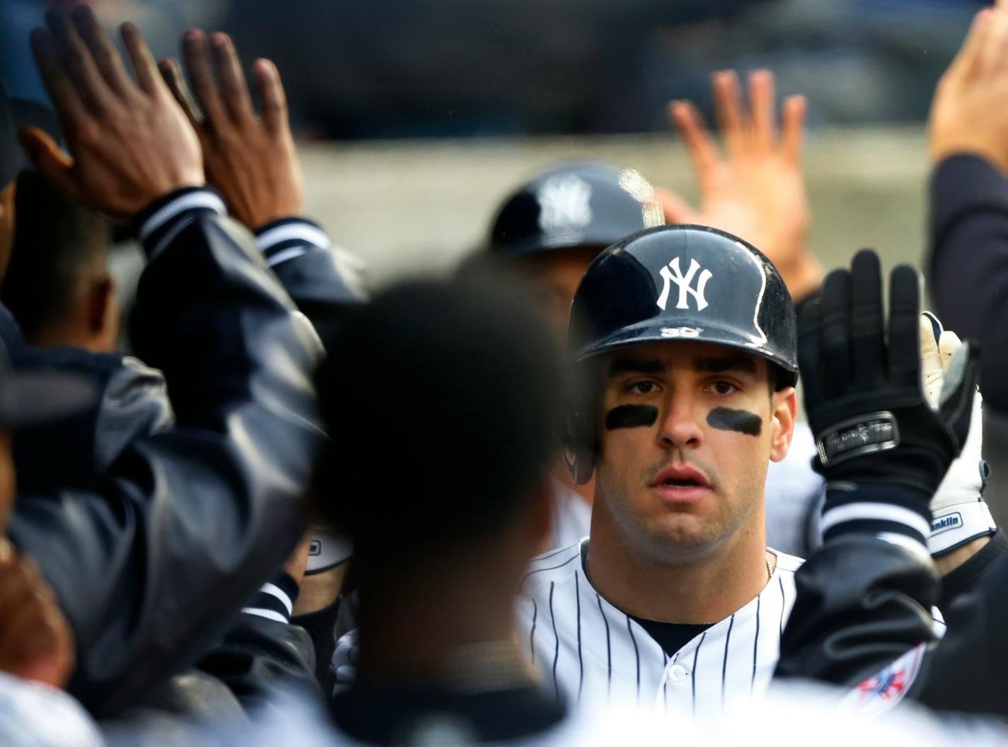 The Yankees' Mike Tauchman celebrated in the dugout after hitting a two-run home run against the Twins in the fourth inning Sunday.