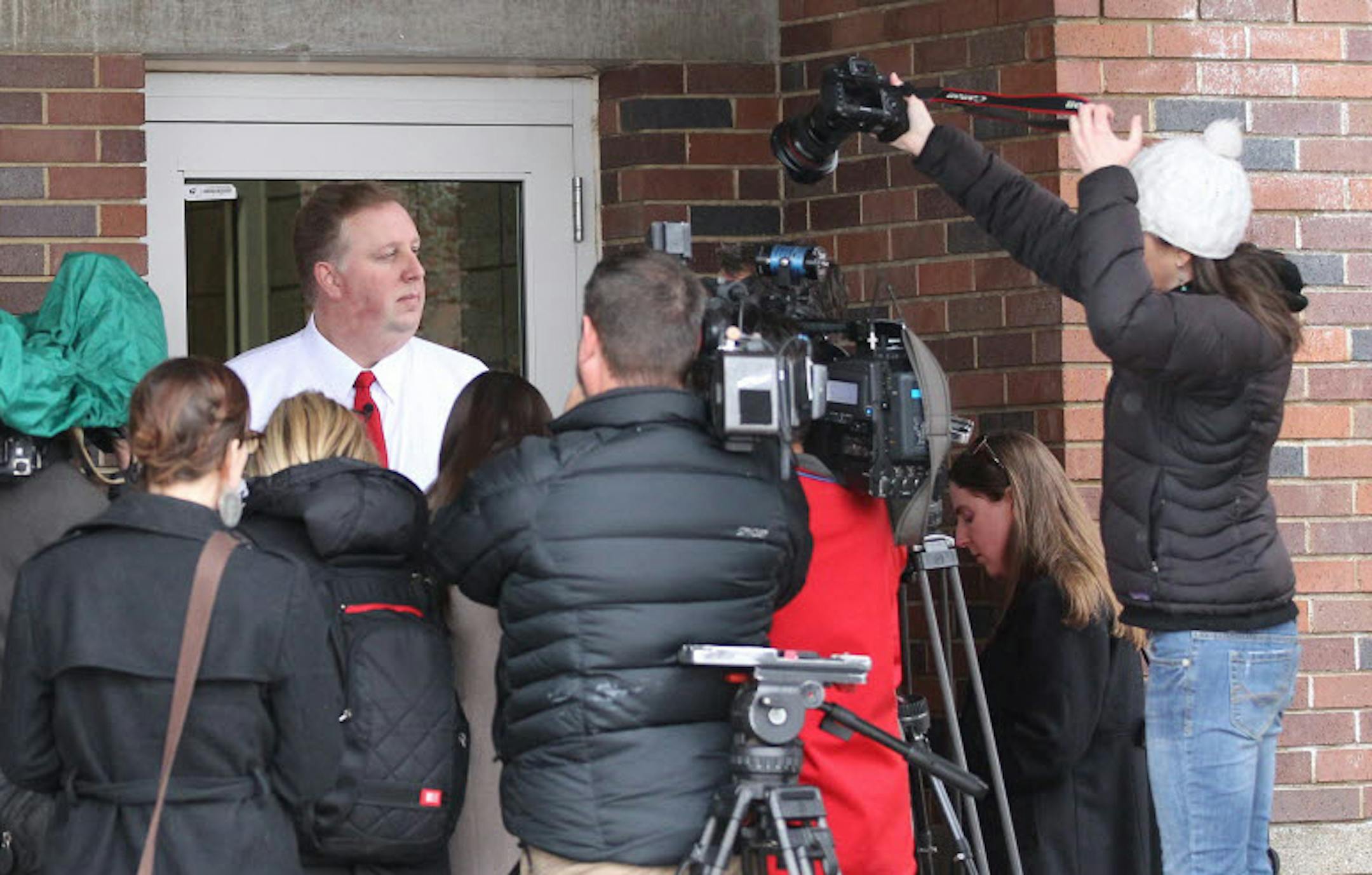 Salt Lake City School District spokesman Jason Olsen speaks to reporters in the doorway of Uintah Elementary School Thursday, Jan. 30, 2014, in Salt Lake City.