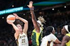 Indiana Fever guard Caitlin Clark (22) shoots as Seattle Storm guard Jordan Horston defends during the second half.