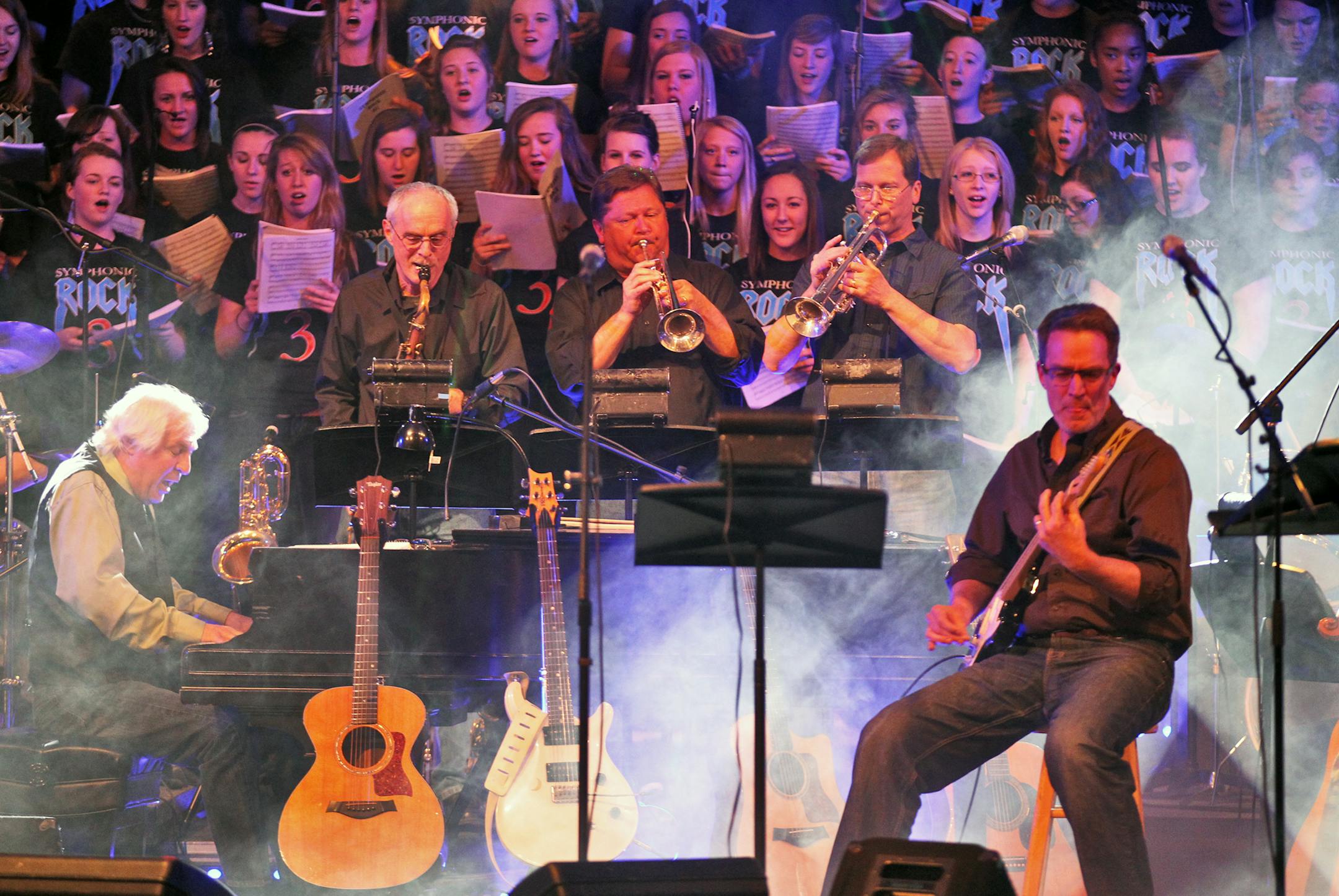 Faculty and staff members of Anoka High have a rock band called Staff Infection that combined with the student symphonic orchestra to perform a recent concert at Anoka high school. Faculty band with student choir behind them. (MARLIN LEVISON/STARTRIBUNE(mlevison@startribune.com (cq all names program)