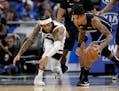 Orlando guard Markelle Fultz, right, scoops up a loose ball next to Timberwolves guard D'Angelo Russell during the second half