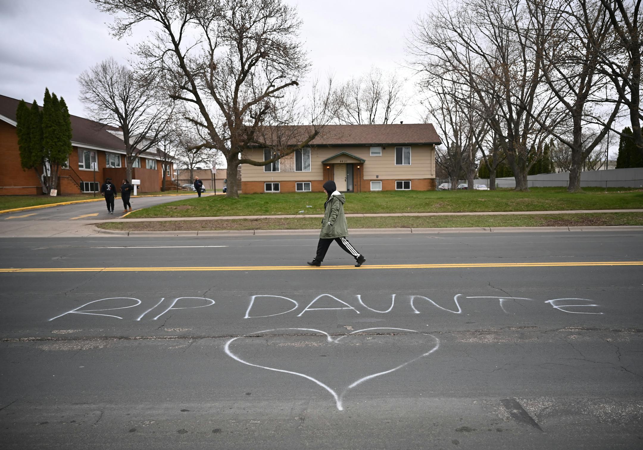 A person walks near the Brooklyn Center Police Department before a protest in response to the fatal police shooting of Daunte Wright, Wednesday, April 14, 2021 in Brooklyn Center, Minn. Former Brooklyn Center police officer Kimberly Potter was charged with second degree manslaughter after the shooting. ] AARON LAVINSKY • aaron.lavinsky@startribune.com