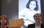 Teresien da Silva, left, and Ronald Leopold of the Anne Frank Foundation show a facsimile of Anne Frank's diary with two pages taped off during a pres
