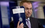 Budget Director Mick Mulvaney held up a copy of President Donald Trump's proposed fiscal 2018 federal budget in the Press Briefing Room of the White H