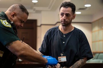 Ehsan Karam glanced at victim Holly Appell as he was fingerprinted after he was sentenced to two years in jail at the Orange County Courthouse on Thur