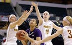 Northwestern forward Nia Coffey shoots between, left to right, Minnesota guard Shayne Mullaney, center Jessie Edwards and guard Carlie Wagner.
