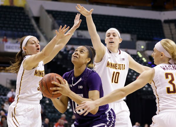 Northwestern forward Nia Coffey shoots between, left to right, Minnesota guard Shayne Mullaney, center Jessie Edwards and guard Carlie Wagner.