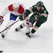 The Wild's Zach Parise fought for possession of the puck against the Canadiens' Kenny Agostino in the third period Tuesday.