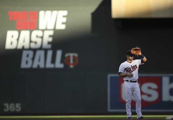 Minnesota Twins second baseman Brian Dozier shaded his eyes from the sun in the second inning.
