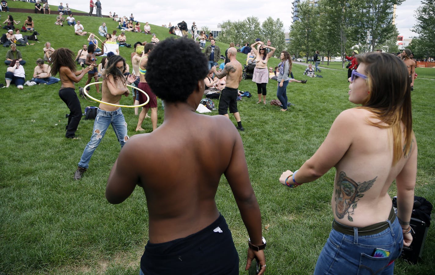 Saying it&#x2019;s a matter of gender equity and freedom of expression, topless demonstrators danced at Gold Medal Park Sunday August 23, 2015 in Minneapolis, MN.