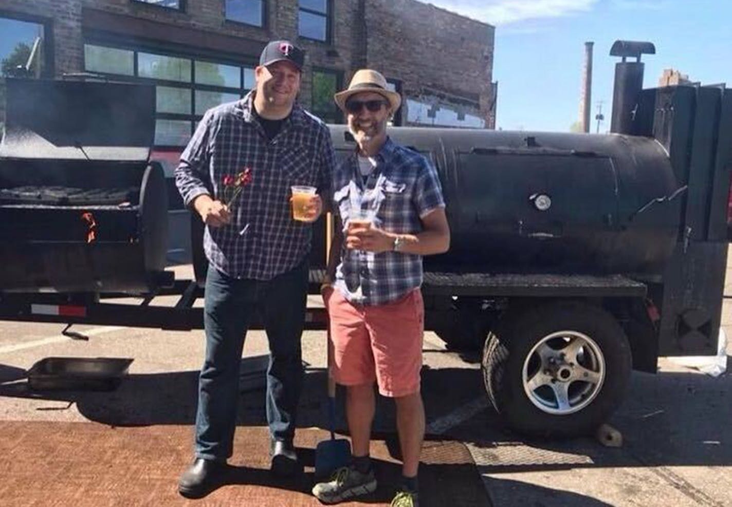 Chef Thomas Boemer, left, with restaurant consultant Pat Weber, right, in front of Boemer's Lang smoker at an event in Minneapolis.