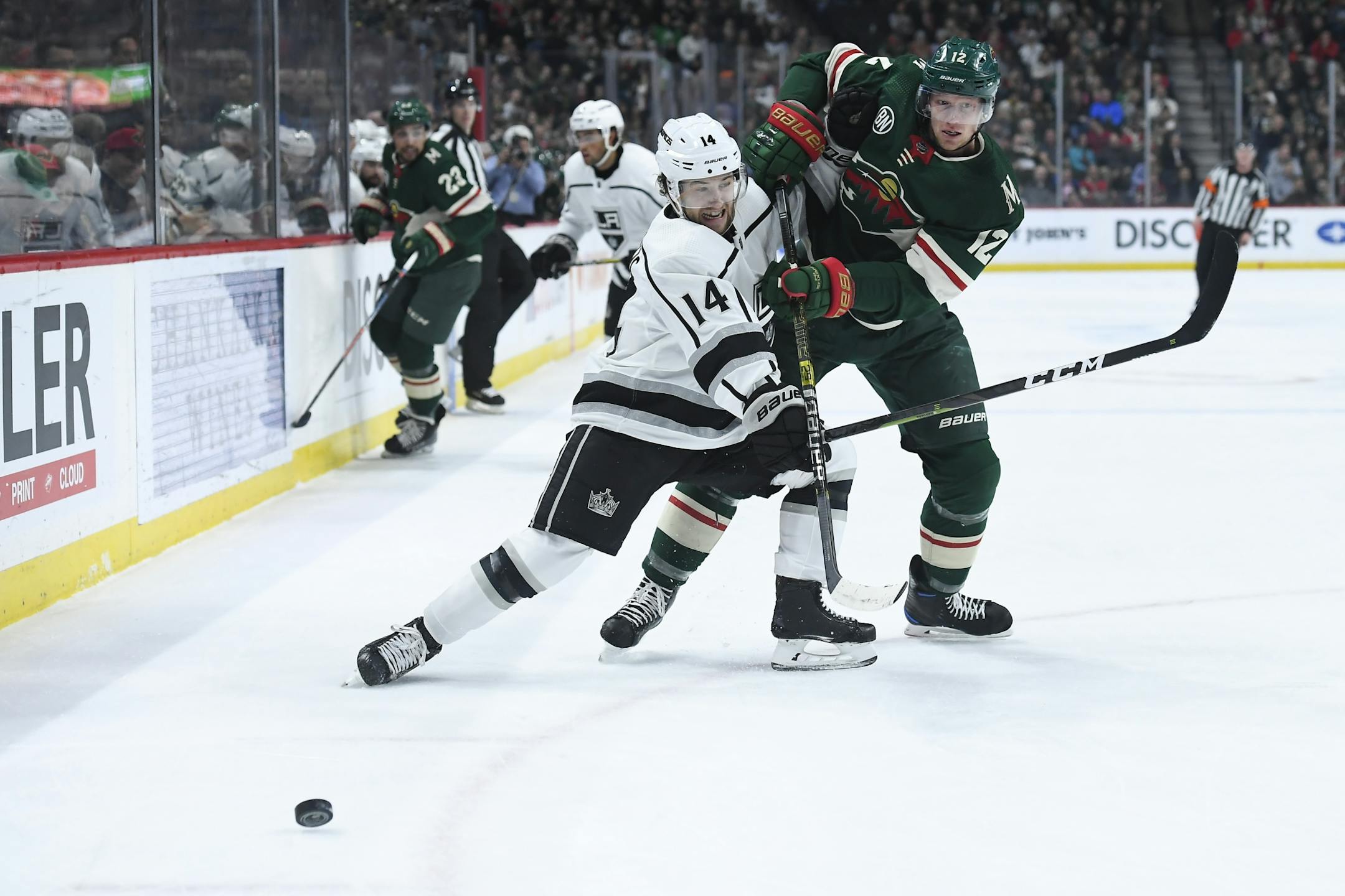 Los Angeles Kings left wing Brendan Leipsic (14) and Minnesota Wild center Eric Staal (12) battled for the puck in the first period.