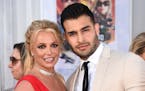 FILE - Britney Spears and Sam Asghari appear at the Los Angeles premiere of "Once Upon a Time in Hollywood" on July 22, 2019. Spears has reached a div