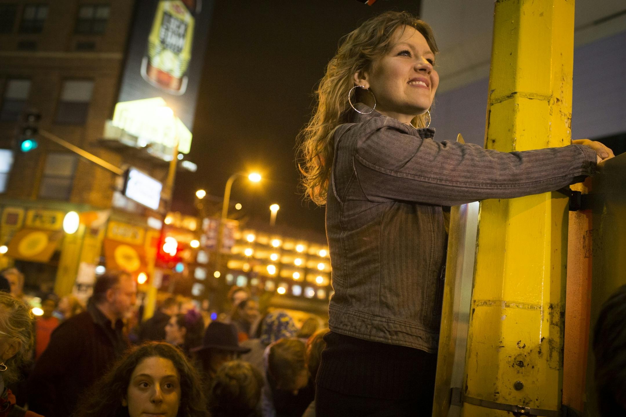 Brook Holmberg climbed a traffic light to get a better view over a huge crowd that came out for a Prince dance party outside of First Avenue on Thursday night, April 21, 2016.