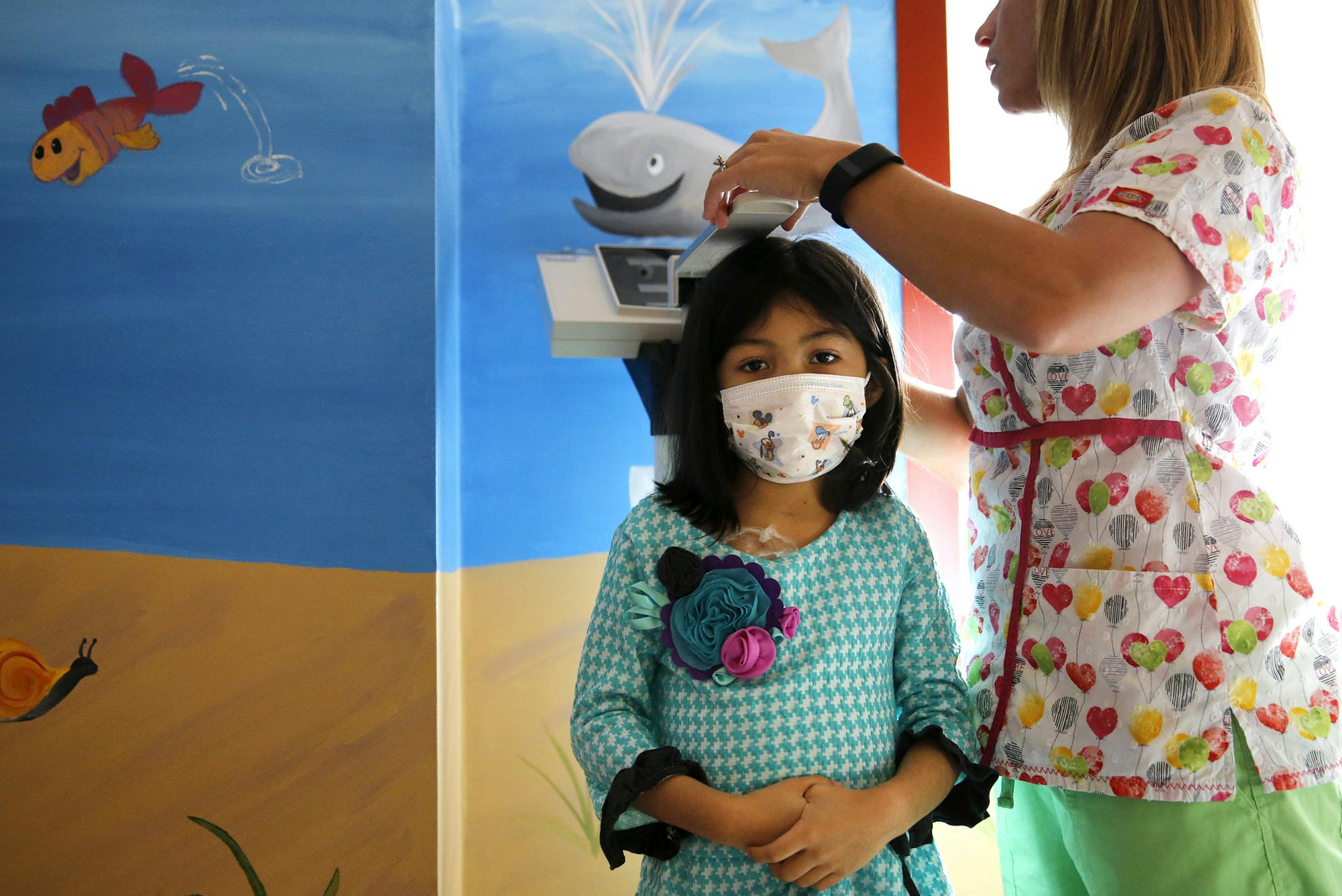 Sophia Sambo, 6, has her weight and height measured by registered nurse Ann Marie Anzalone at Advocate Children's Hospital in Park Ridge, Ill., for her regular treatment on Friday, Sept. 4, 2015. (Jose M. Osorio/Chicago Tribune/TNS)
