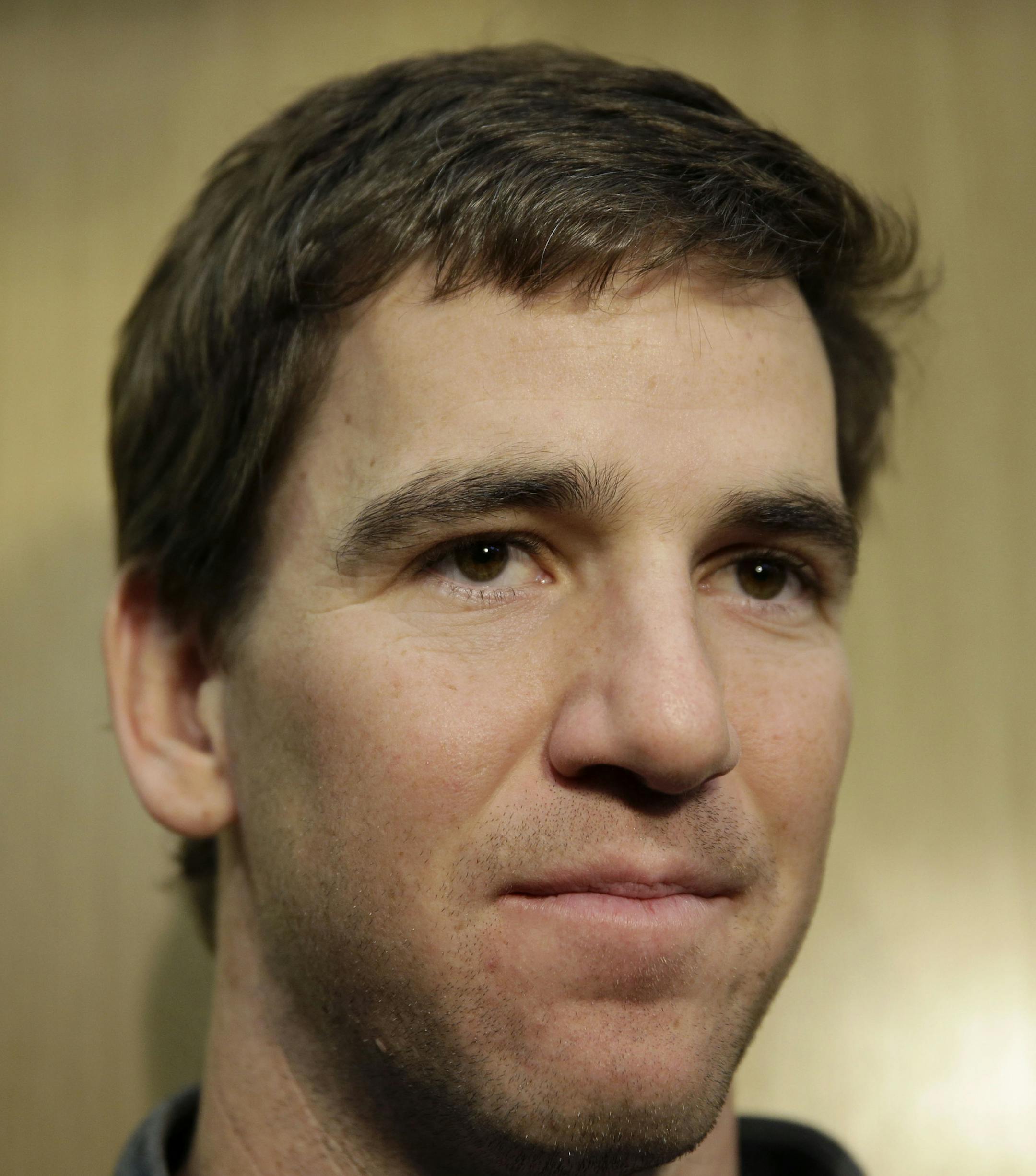 New York Giants Eli Manning talks to reporters in the team locker room in East Rutherford, N.J., Monday, Jan. 4, 2016. (AP Photo/Seth Wenig)