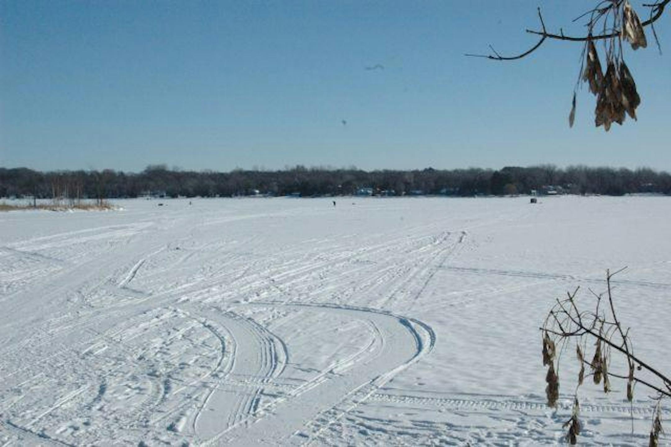 Two lonely ice fishermen test their luck and their pack boots on Lake Carnelian.