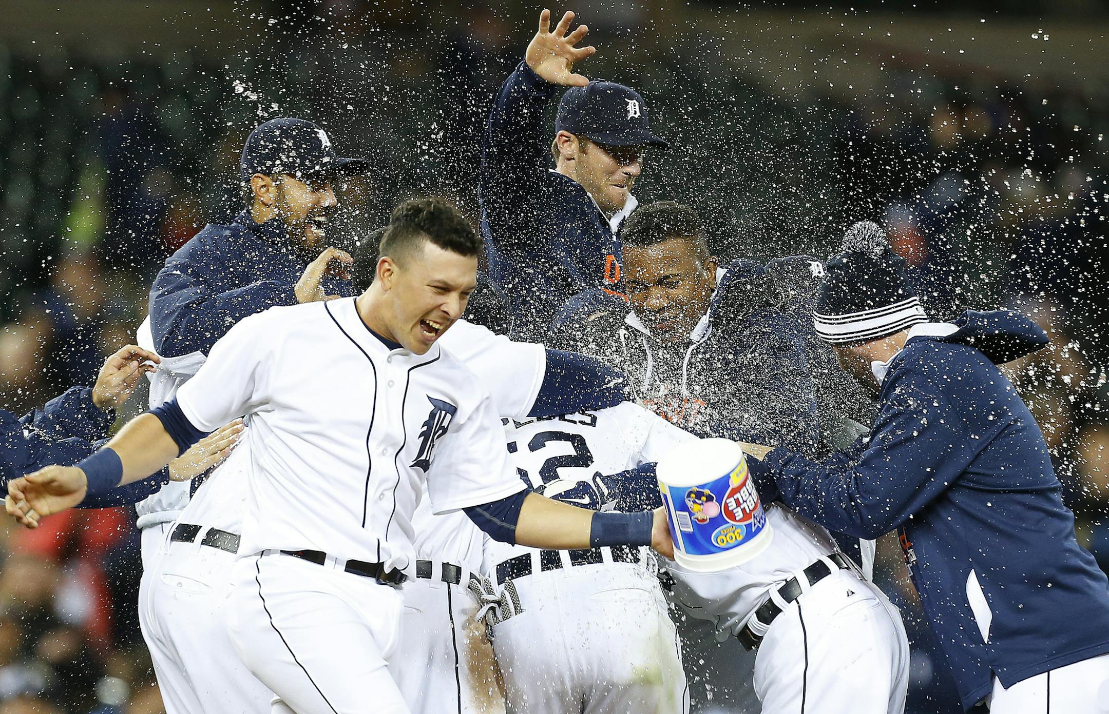 Detroit Tigers players celebrate an Ian Kinsler game winning single scoring Anthony Gose against the Minnesota Twins in the tenth inning of a baseball game in Detroit Tuesday, May 12, 2015. Detroit won 2-1. (AP Photo/Paul Sancya)