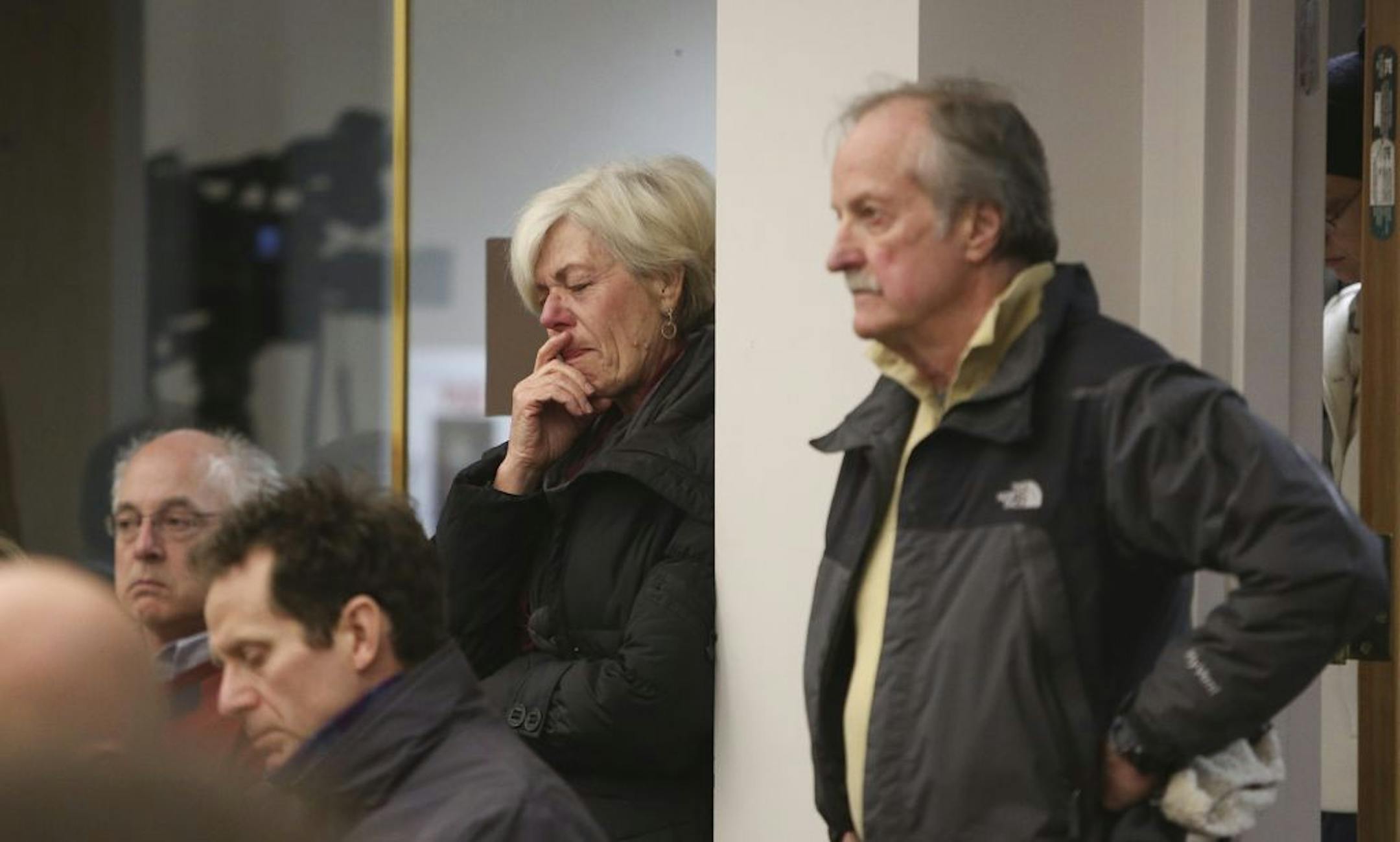 Golden Valley Robin Price wiped tears with her husband William Steacker standing next to her as they listened to the discussion about the Bottineau light rail line at City Hall in Golden Valley Min., Tuesday December 18, 2012. The vote went 3-2 to approve the proposed route along Wirth Park. The proposed line would go right behind their home on Bassett Creek. "I am devastated," said Price.