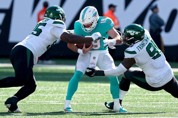 Skylar Thompson (19) of the Miami Dolphins is sacked by Quinnen Williams (95) of the New York Jets and John Franklin-Myers (91) during the second half