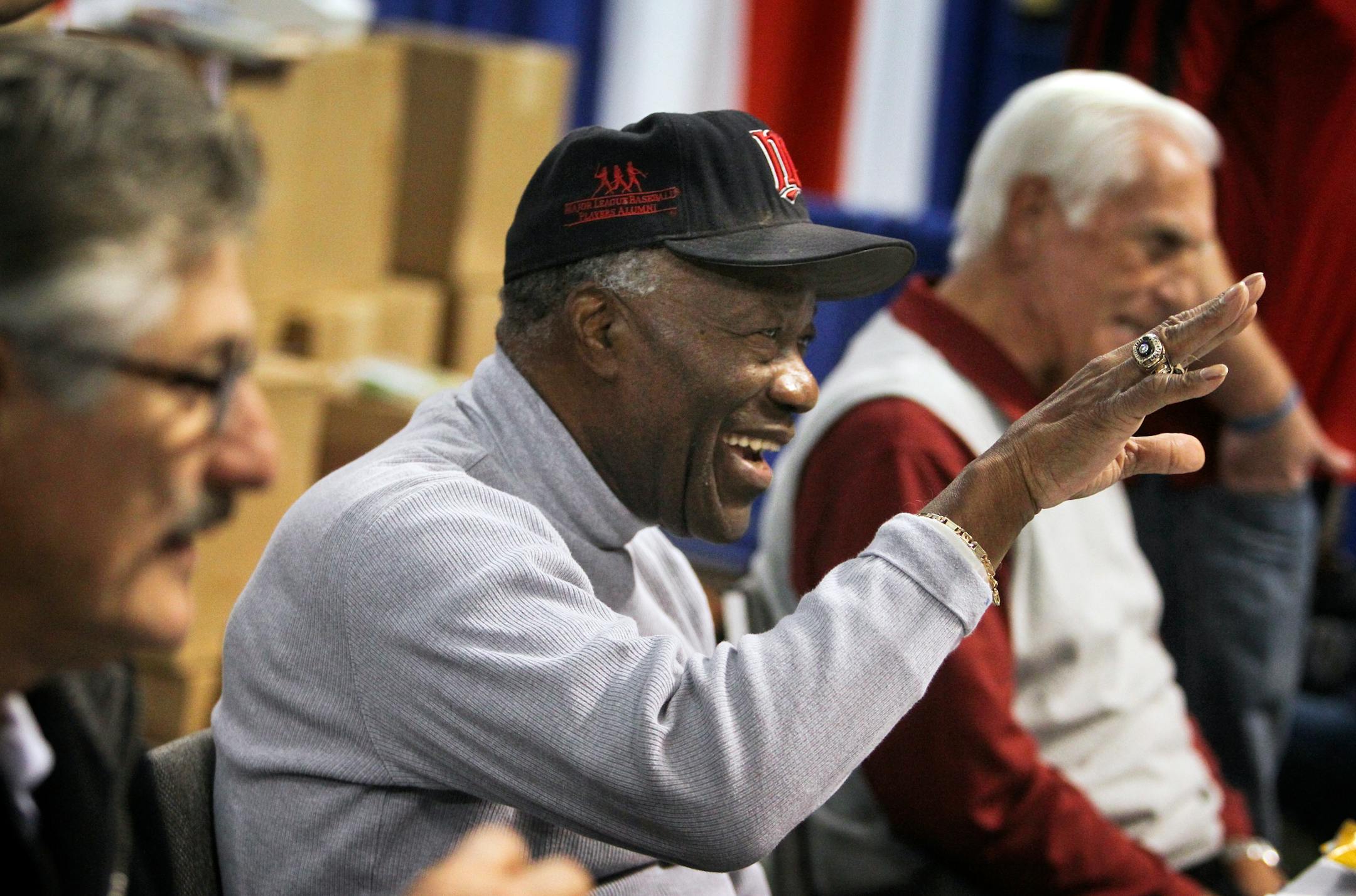 Former Minnesota Twins pitcher Jim "Mudcat" Grant waved to a fan while waiting to sign autographs with other Major League greats Rollie Fingers, left, and former Twin Jim Perry, right, at Twinsfest Friday, Jan. 25, 2013, at the Metrodome.