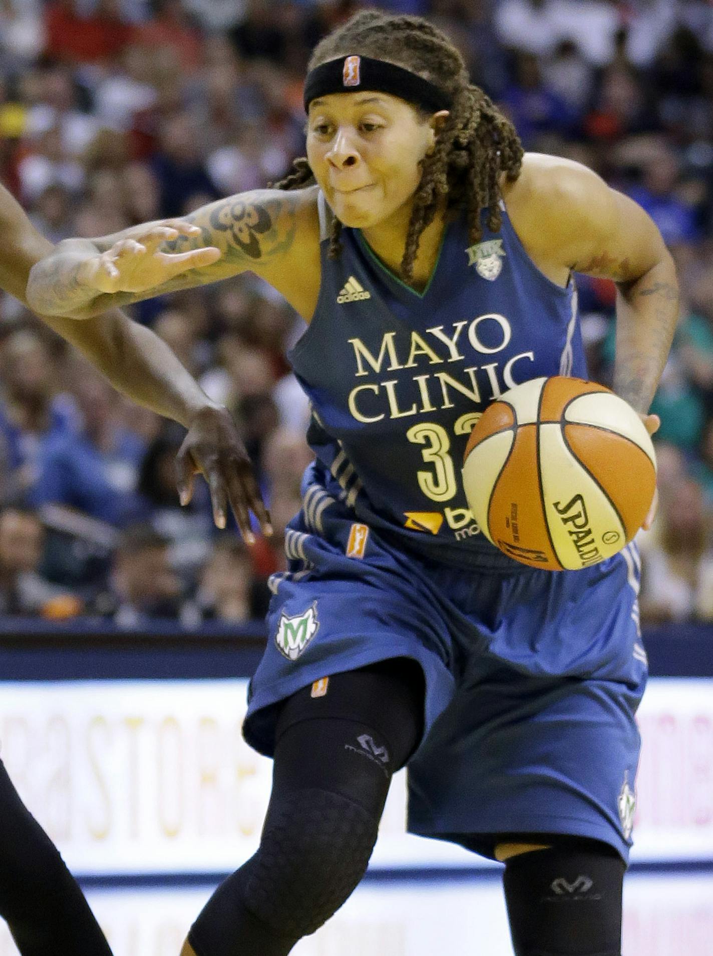 Minnesota Lynx's Seimone Augustus, right, tries to drive around Indiana Fever's Natasha Howard in the second half of Game 4 of the WNBA Finals basketball series, in Indianapolis, Sunday, Oct. 11, 2015. (AP Photo/Michael Conroy)