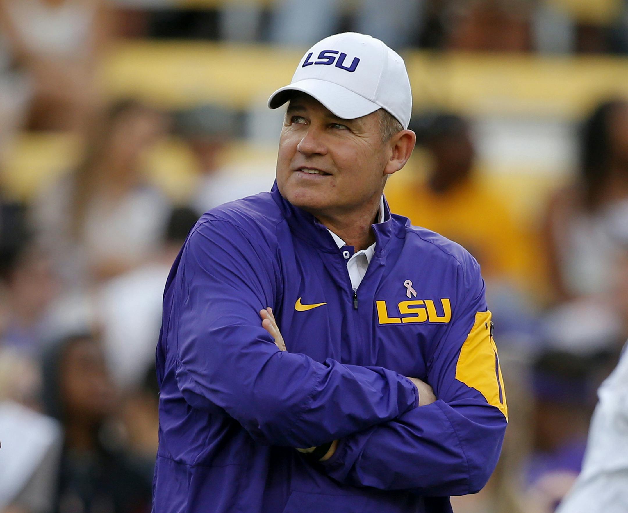 FILE - In this Oct. 17, 2015, file photo, LSU coach Les Miles watches his team warm up before an NCAA college football game against Florida in Baton Rouge, La. That Les Miles could be even considered to be on the dreaded hot seat at LSU entering this season tells you all you need to know about job security among college football coaches these days _ especially those in the Southeastern Conference. (AP Photo/Gerald Herbert, File) ORG XMIT: NY158
