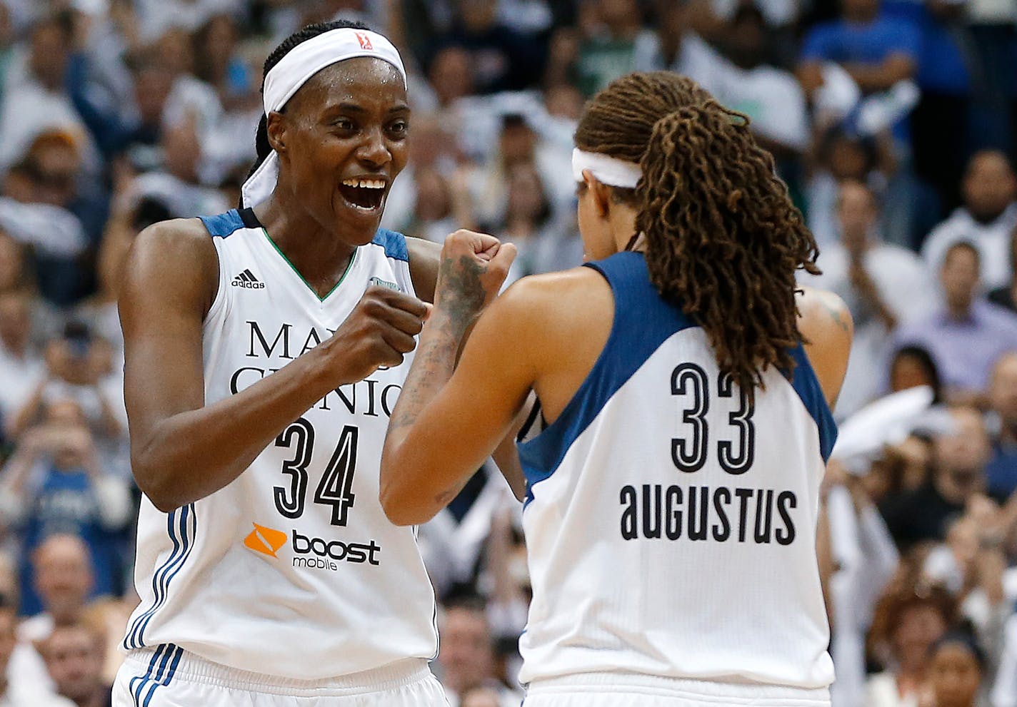 FILE - In this Oct. 14, 2015, file photo, Minnesota Lynx center Sylvia Fowles (34) celebrates with Seimone Augustus (33) after beating the Indiana Fever 69-52 in Game 5 of the WNBA finals in Minneapolis.