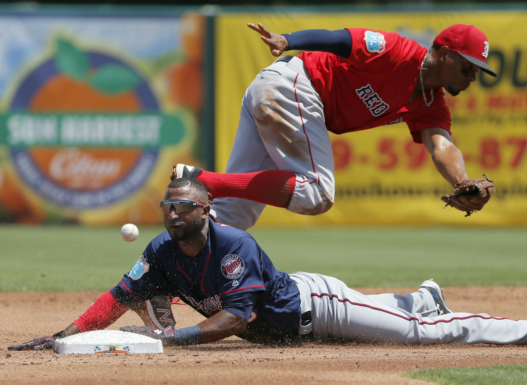 Minnesota Twins' Eduardo Nunez steals second as Boston Red Sox shortstop Xander Bogaerts reaches out but misses on a wide throw to the bag in the second inning of a spring training baseball game, Thursday, March 31, 2016, in Fort Myers, Fla. (AP Photo/Tony Gutierrez)