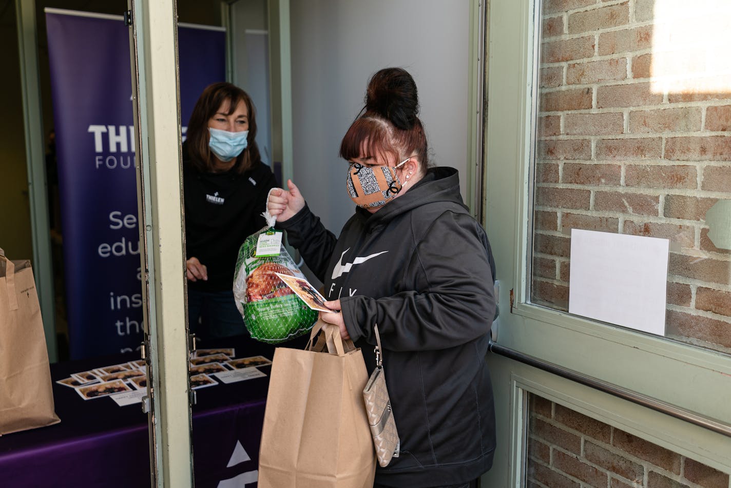 Amy Sinclair, Executive Director of Thielen Foundation, handed out turkeys at East St. Paul Worship and Service Center of the Salvation Army.